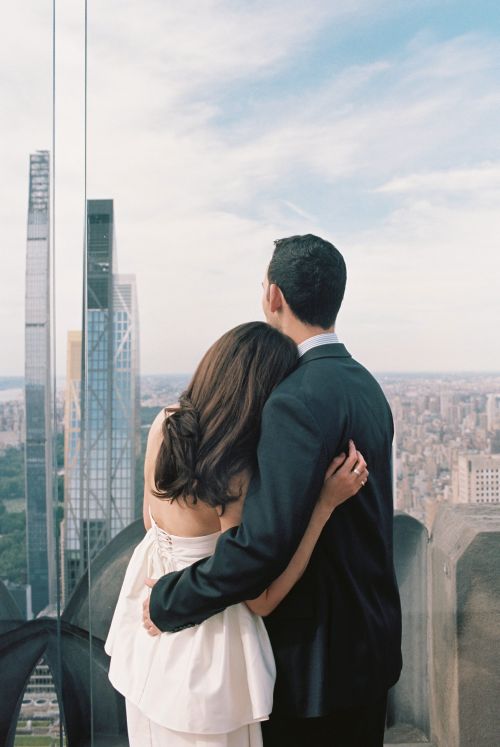 Bride and groom overlooking central park from empire state building during elopement in new york city