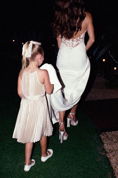 Girl holds wedding dress in chileno bay auberge resort in los cabos