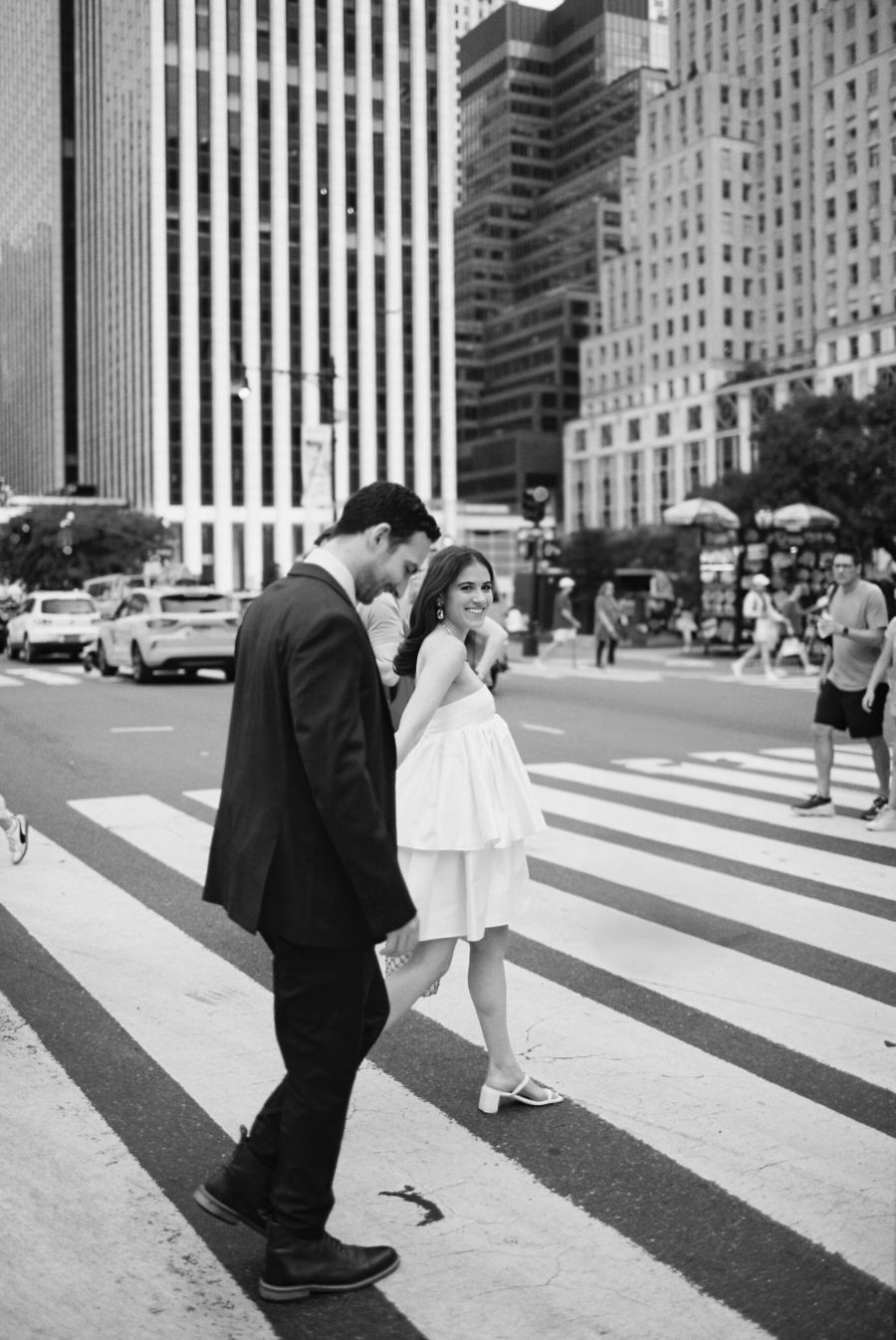 Bride and groom walking in fifth avenue in new york city during elopement