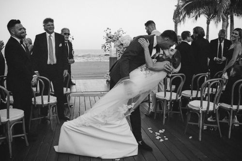 Kiss deep of bride and groom at ceremony wedding in chileno bay auberge resort in los cabos