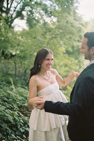 Bride and groom overlooking pond in central park in new york city during elopement